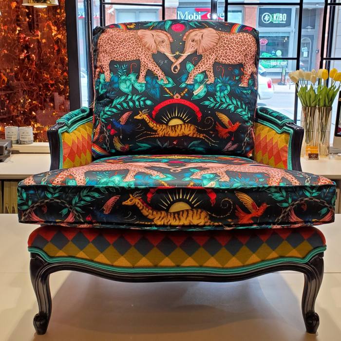 Classic pieces upholstered with strident contemporary patterns and prints . . . A vintage wooden chair with cushions embellished with a striped pattern and wildlife print at Kendall & Co